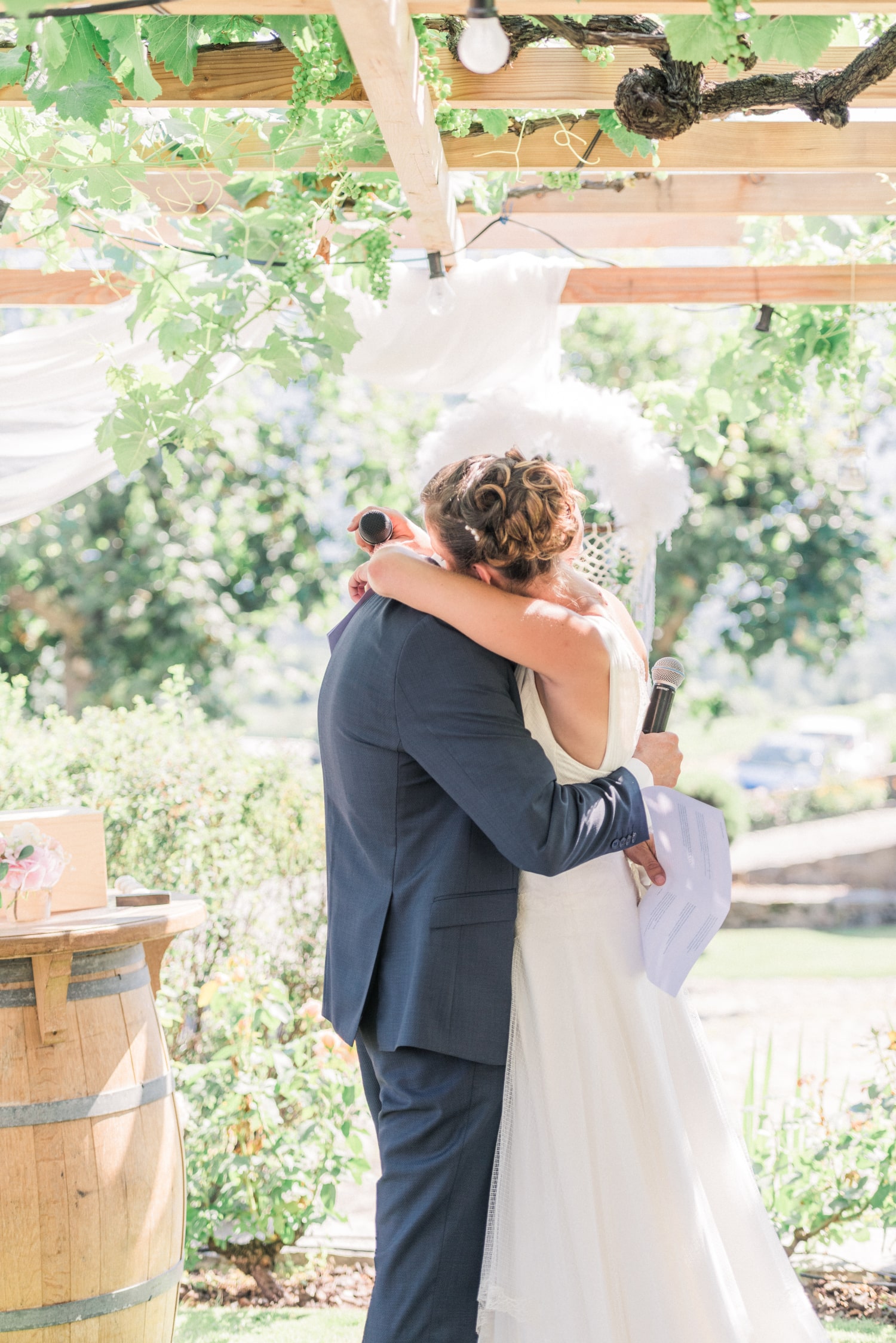 The bride and groom hold each other after exchanging their vows