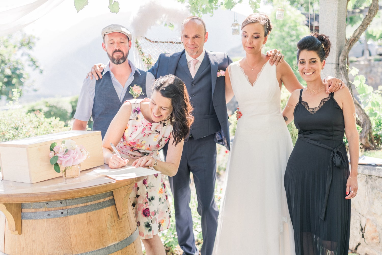 The newlyweds and their witnesses sign a symbolic certificate together