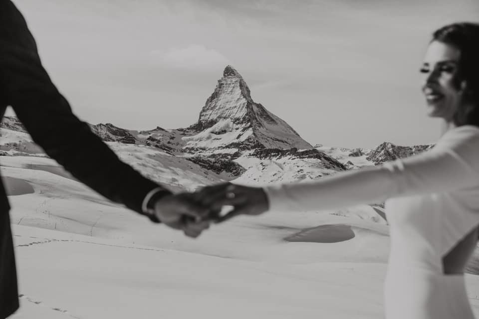 Couple hand in hand in front of Zermatt Matterhorn