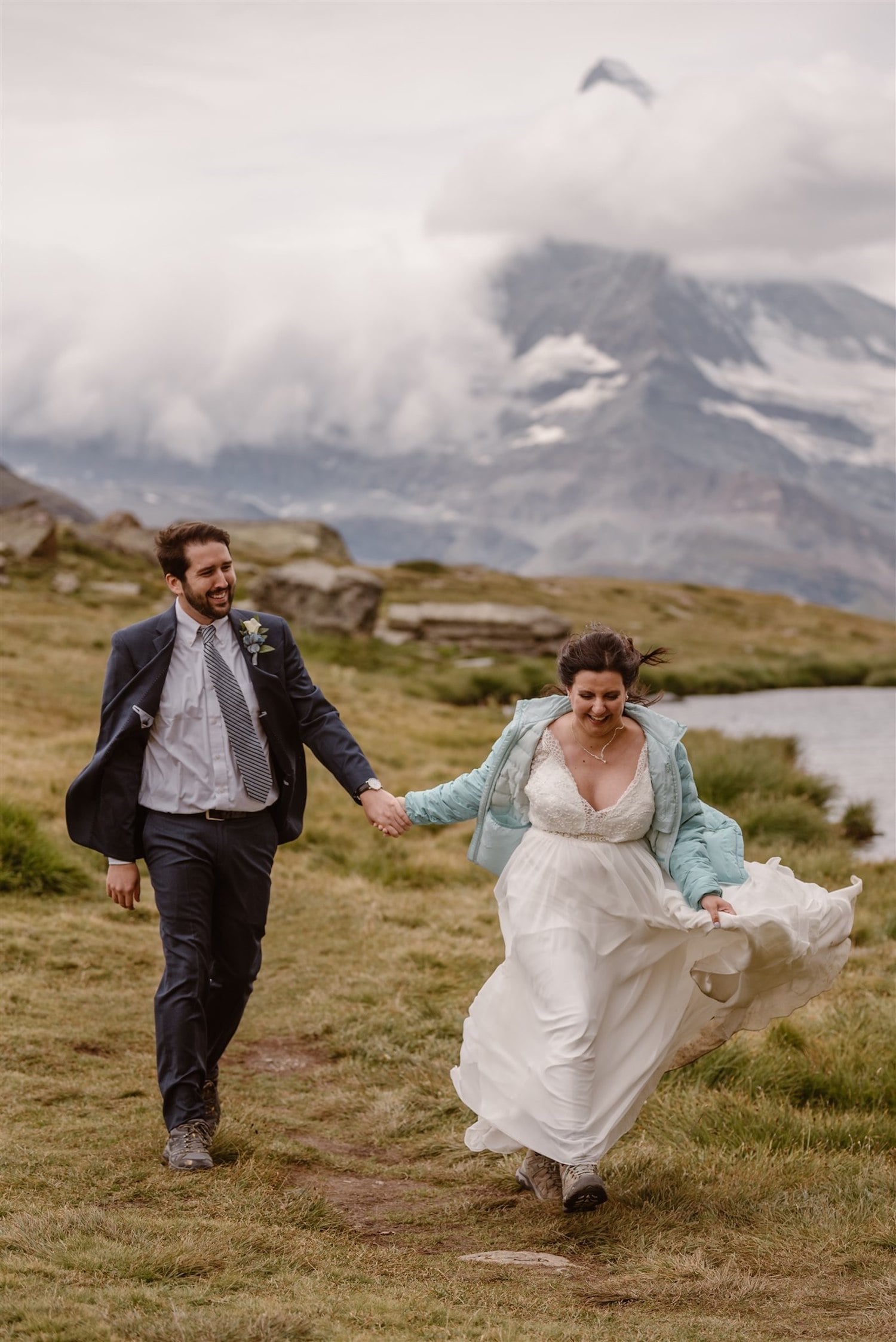 Bride and groom happily running in front of the Matterhorn