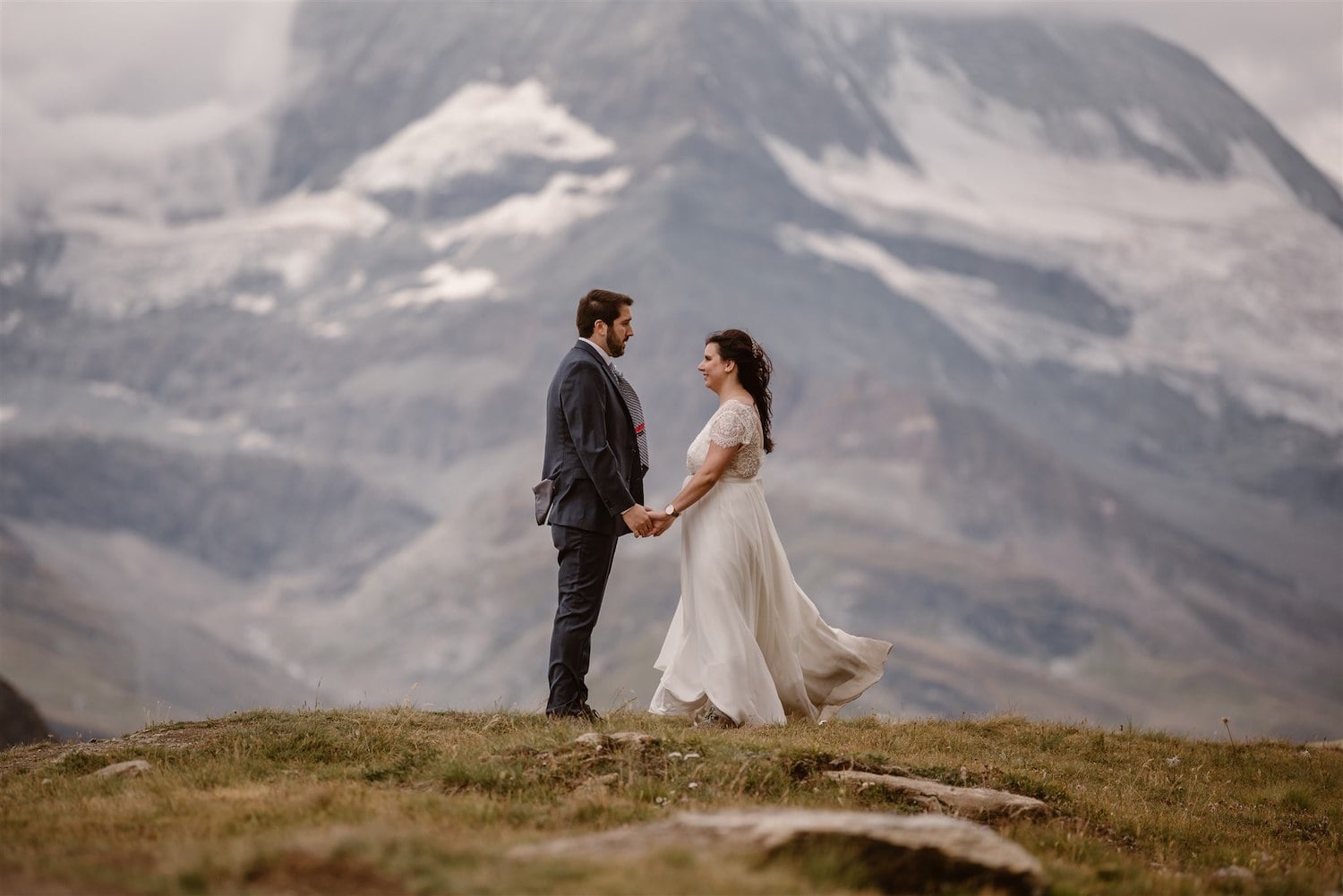 Newlyweds holing hands after their commitment ceremony in Zermatt