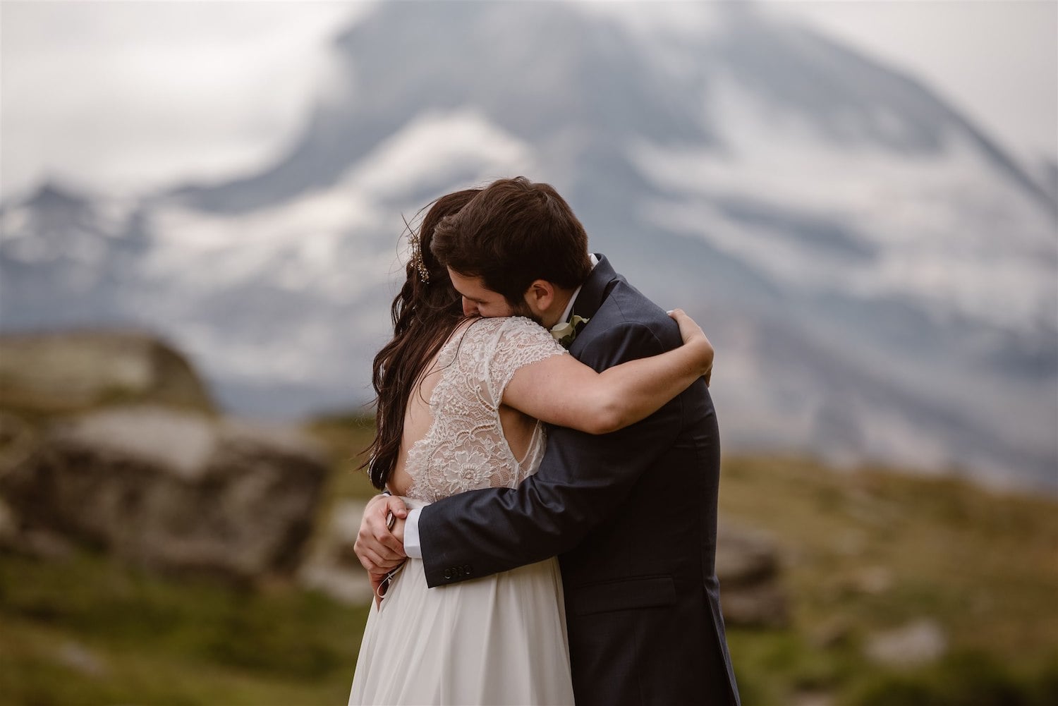 Newlyweds hugging after their marriage ceremony in the Swiss mountains