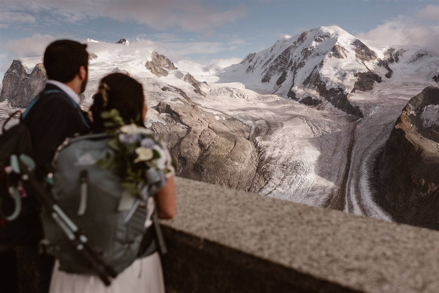 Couple looking at the mountain after their elopement ceremony in Switzerland