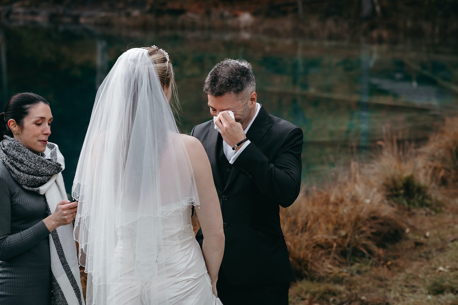 Groom crying during his elopement in Blausee