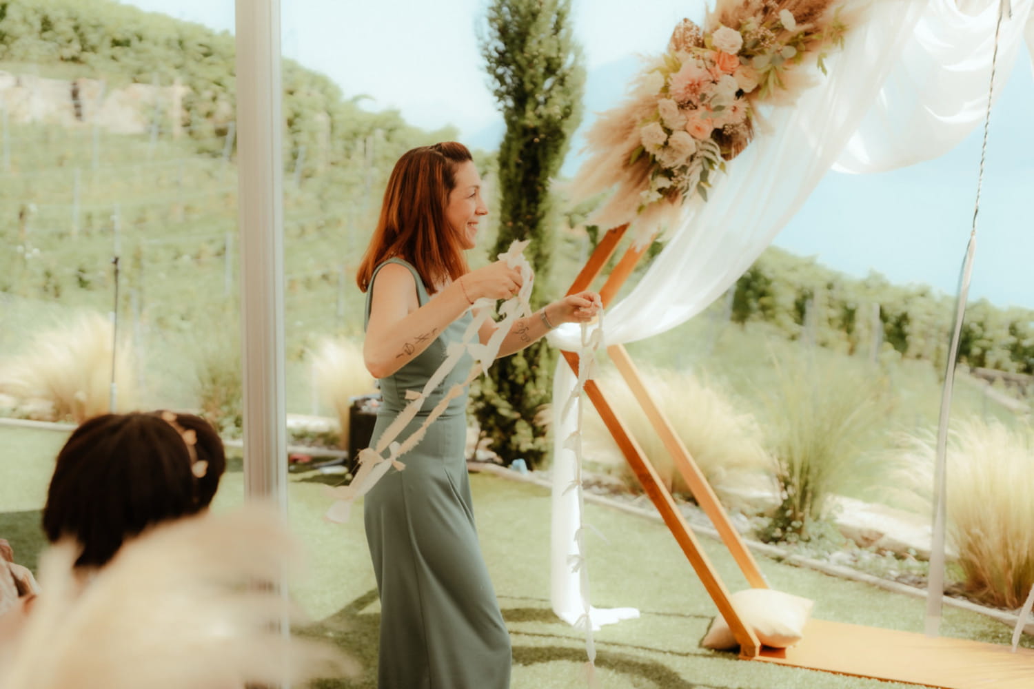 Celebrant holding ribbons during symbolic ceremony in Lavaux, Switzerland