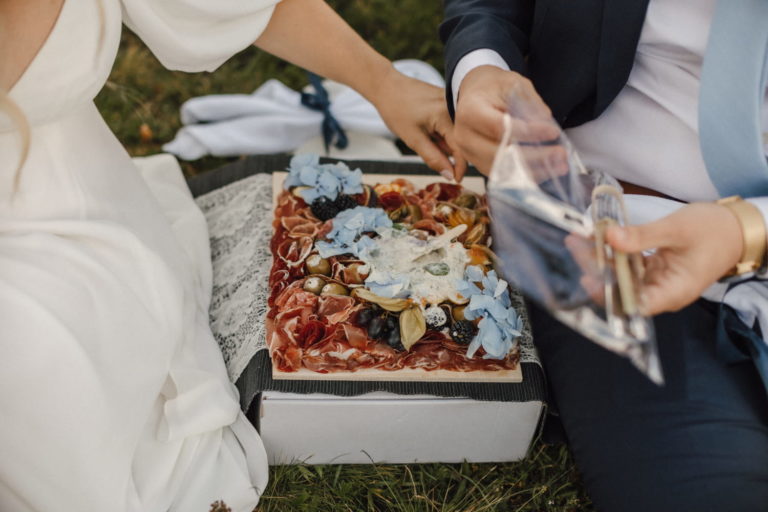 Couple having picnic after their wedding ceremony